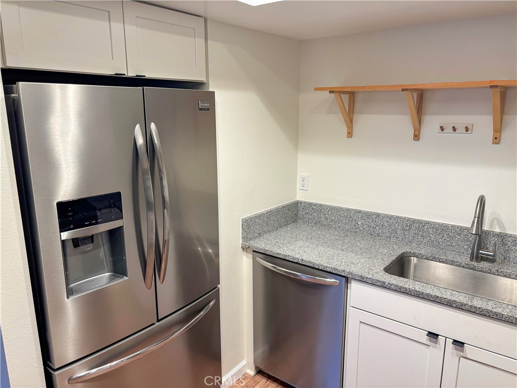 1445 Prefumo Canyon Road, Unit 20 San Luis Obispo, CA 93405 - Photo 4 of 19 a kitchen with metallic refrigerator and sink