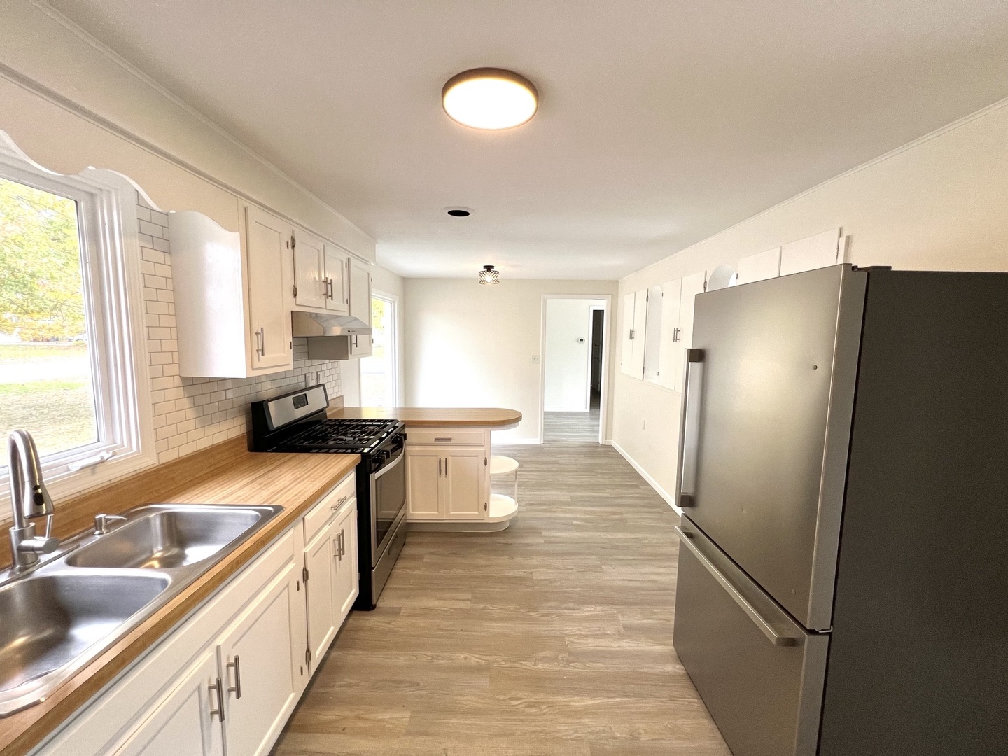 1630 Jonathan Avenue Rockford, IL 61103 - Photo 12 of 23 a kitchen with stainless steel appliances granite countertop a refrigerator a sink dishwasher a oven with white cabinets and wooden floor