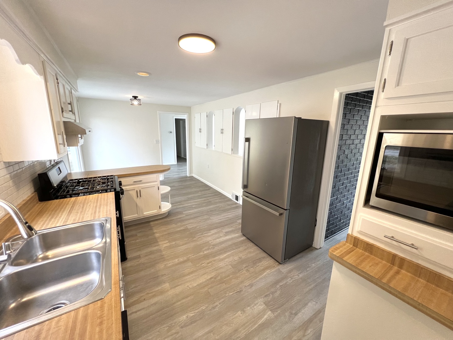 1630 Jonathan Avenue Rockford, IL 61103 - Photo 13 of 23 a kitchen with stainless steel appliances a refrigerator and a stove top oven