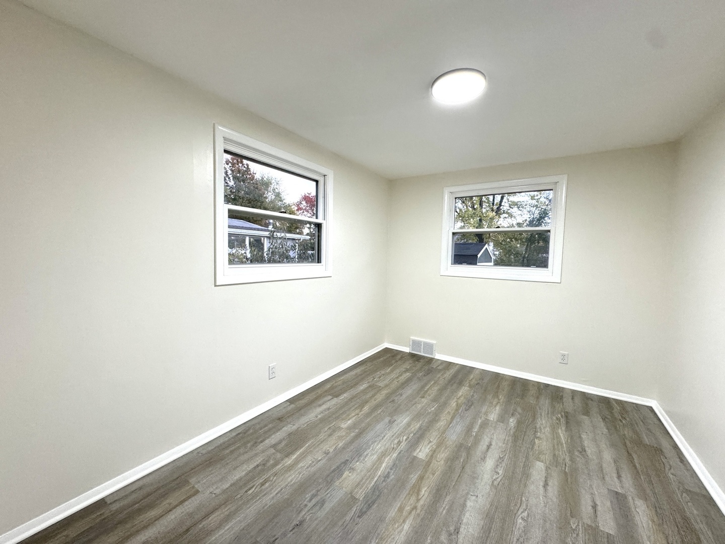 1630 Jonathan Avenue Rockford, IL 61103 - Photo 2 of 23 an empty room with wooden floor and windows