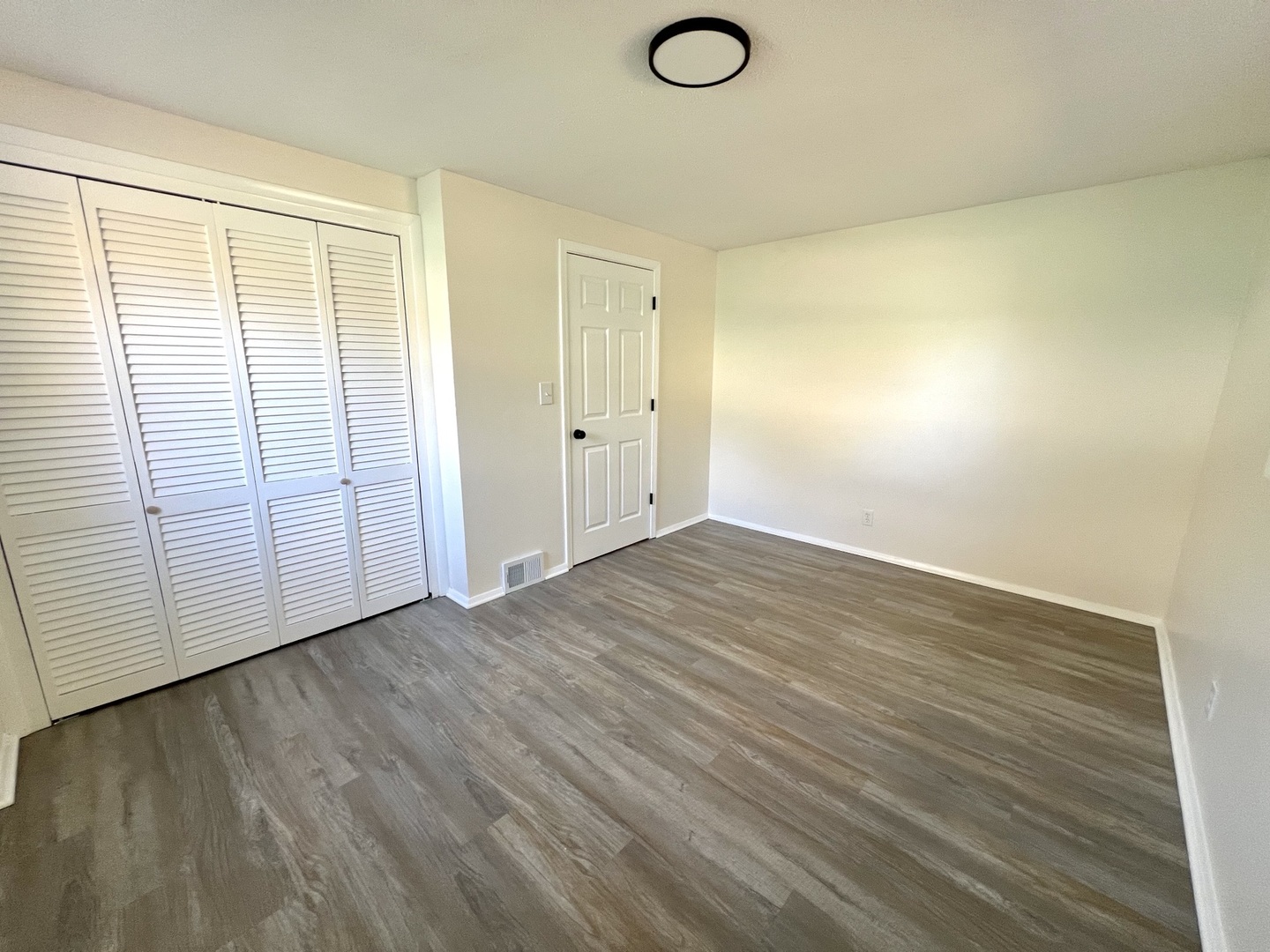 1630 Jonathan Avenue Rockford, IL 61103 - Photo 23 of 23 an empty room with wooden floor and windows