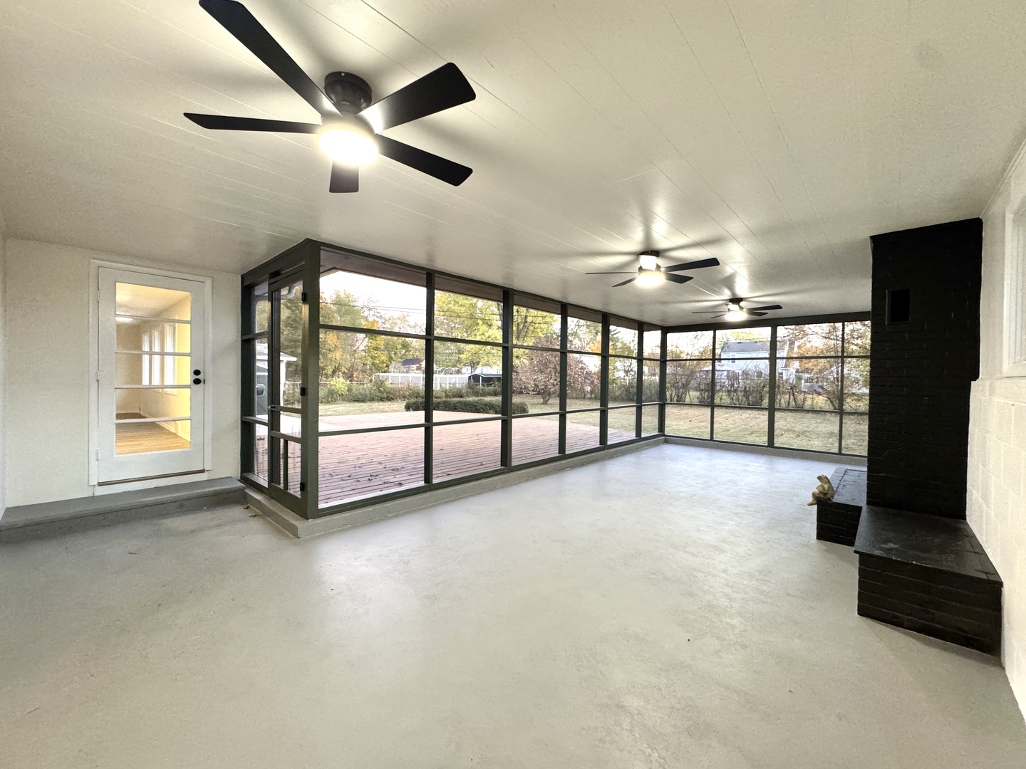 1630 Jonathan Avenue Rockford, IL 61103 - Photo 4 of 23 a view of an empty room with a floor to ceiling window and a ceiling fan