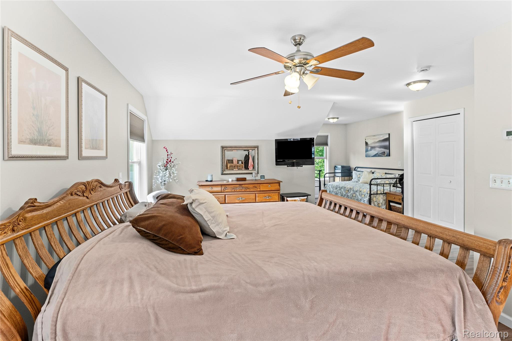 15055 South Duffield Road Byron, MI 48418 - Photo 24 of 61 Spacious room featuring vaulted ceilings, a ceiling fan with integrated lighting, a built-in closet with bi-fold doors, and recessed lighting