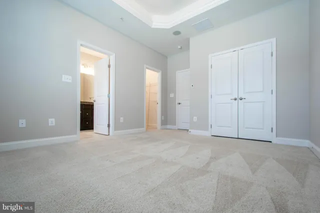 an empty room with windows and closet