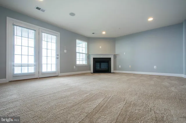 a view of empty room with a fireplace