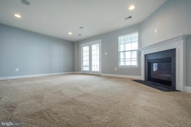 a view of empty room with a fireplace