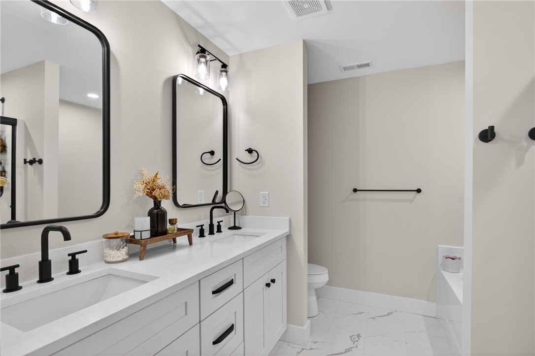 106 Bolt Road Townville, SC 29689 - Photo 15 of 33 A well-lit primary bathroom featuring a double vanity with ample counter space and modern fixtures.