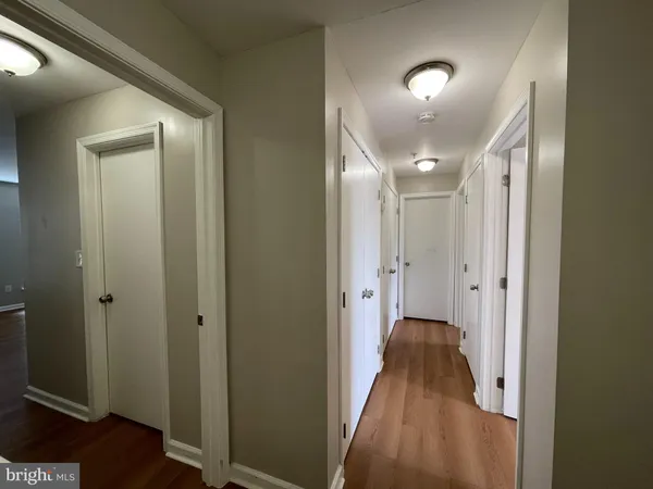 a view of a hallway with wooden floor