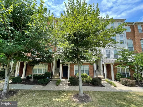 front view of a brick house with a yard