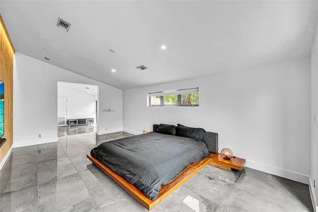 a bedroom with a bed and window