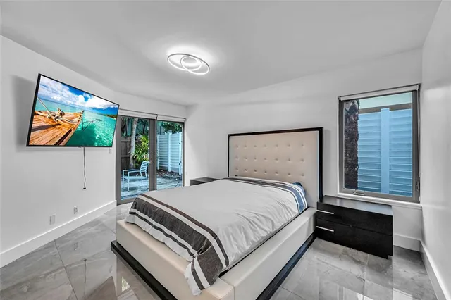 a bedroom with a bed and glass window