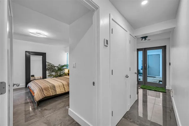 a bedroom with a bed and a mirror