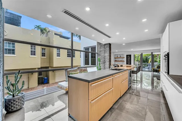 a kitchen with stainless steel appliances kitchen island granite countertop a stove and a refrigerator