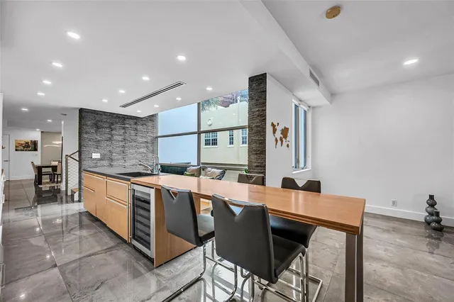 a kitchen with stainless steel appliances kitchen island granite countertop a sink and cabinets