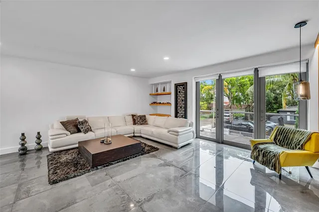 a living room with furniture and large windows