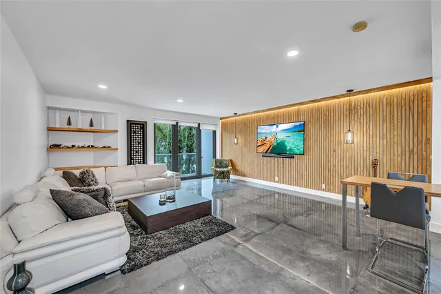 a living room with furniture a rug and a flat screen tv