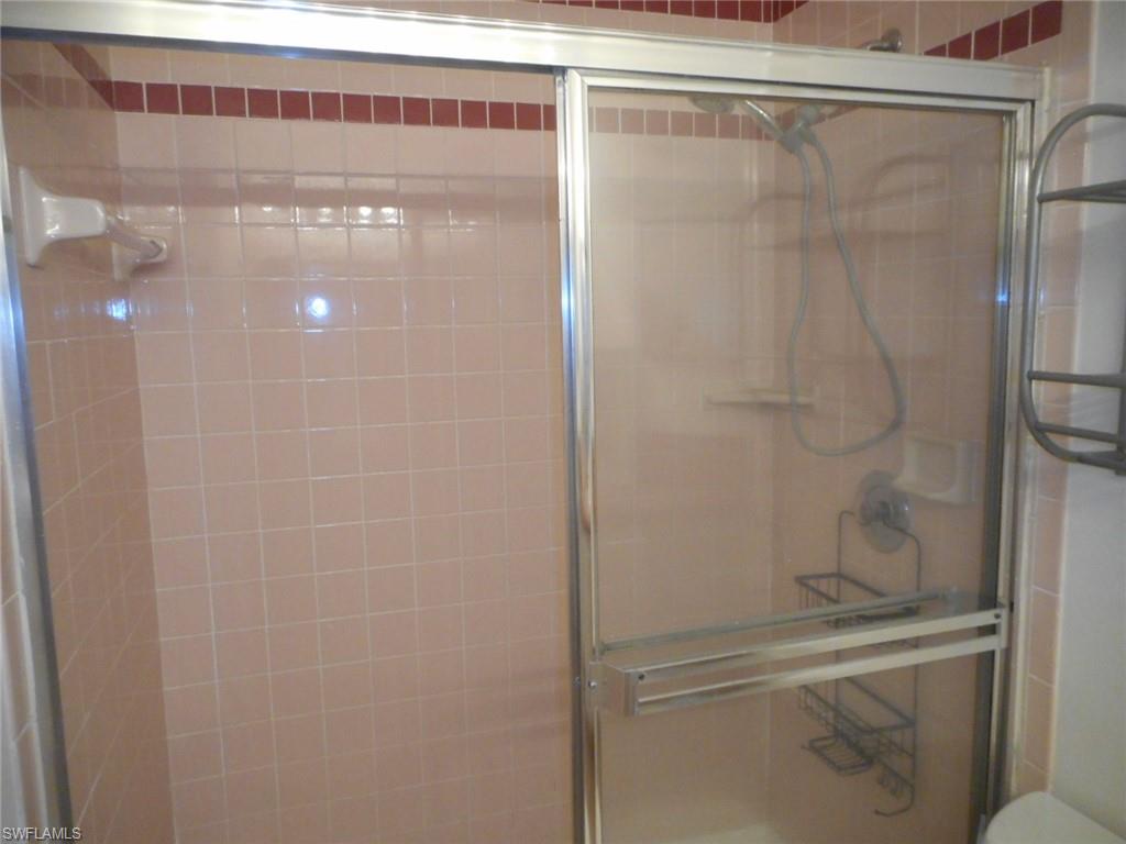 259 Quail Forest Boulevard, Unit 106 Naples, FL 34105 - Photo 11 of 23 a bathroom with a shower