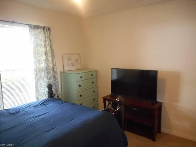 a bedroom with a bed and television