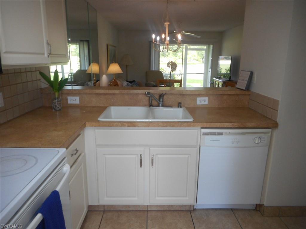 259 Quail Forest Boulevard, Unit 106 Naples, FL 34105 - Photo 23 of 23 a bathroom with a sink and a mirror
