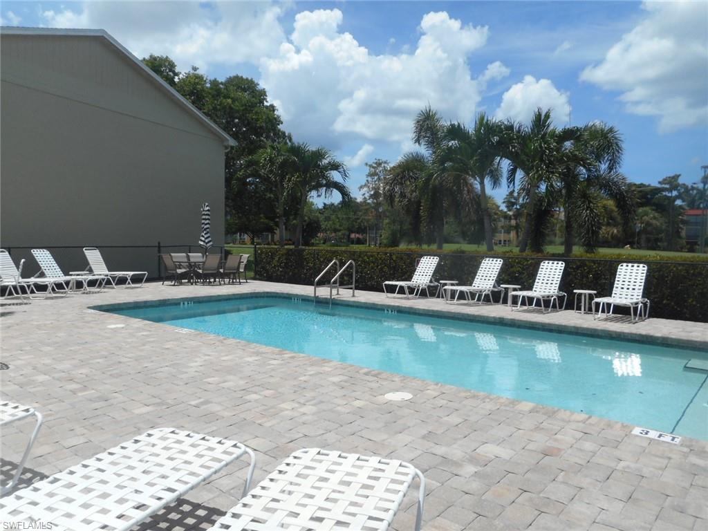 259 Quail Forest Boulevard, Unit 106 Naples, FL 34105 - Photo 21 of 23 a view of swimming pool with outdoor seating and plants