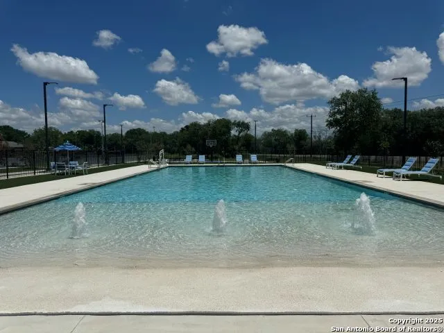 a view of a swimming pool with a yard