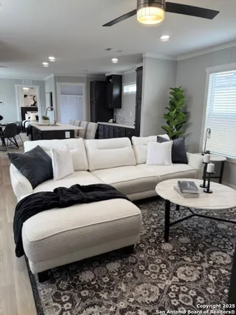 a living room with furniture and a chandelier