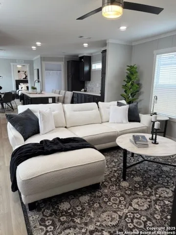 a living room with furniture and a chandelier