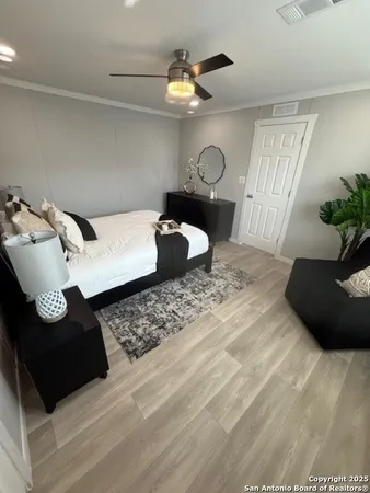 a bedroom with a bed and a chandelier