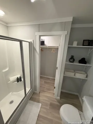 a bathroom with a toilet and a shower
