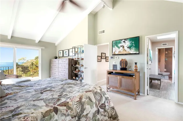 a bedroom with furniture and a flat screen tv