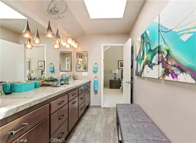 a spacious bathroom with a double vanity sink and a mirror