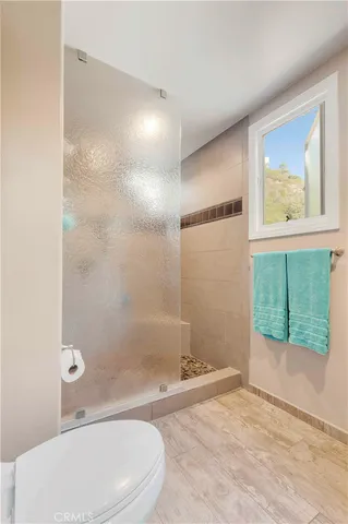 a bathroom with a toilet sink and shower