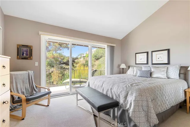 a bedroom with a bed and a view of balcony