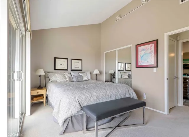 a bedroom with a bed and a painting on the wall