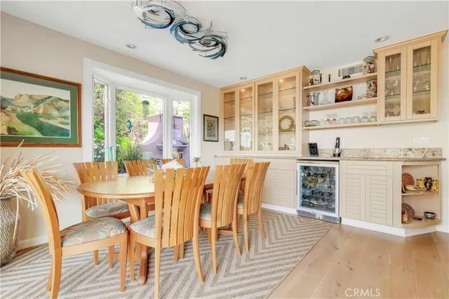 a dining room with furniture a chandelier and wooden floor