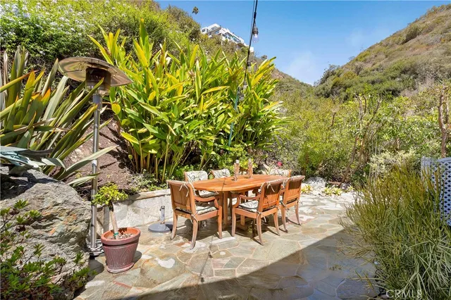 a view of a chairs and table in a backyard