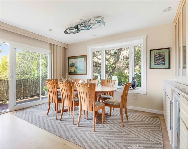 a dining room with furniture wooden floor and a rug