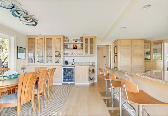 a living room with stainless steel appliances granite countertop furniture and fireplace