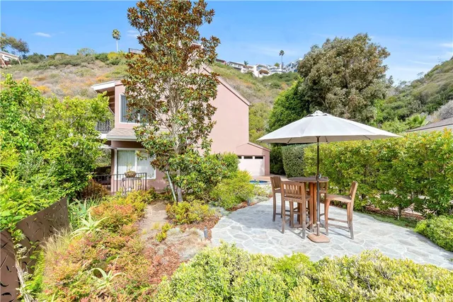 a view of patio with table and chairs under an umbrella