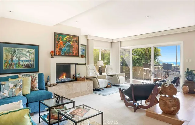 a living room with furniture large window and a fireplace