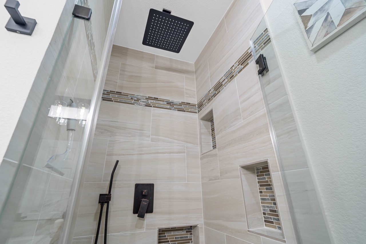 3138 Sunbeam Street Houston, TX 77051 - Photo 38 of 50 Elevated tile accents, built-in niches, and luxury rainfall fixtures transform this shower into a spa-worthy experience.