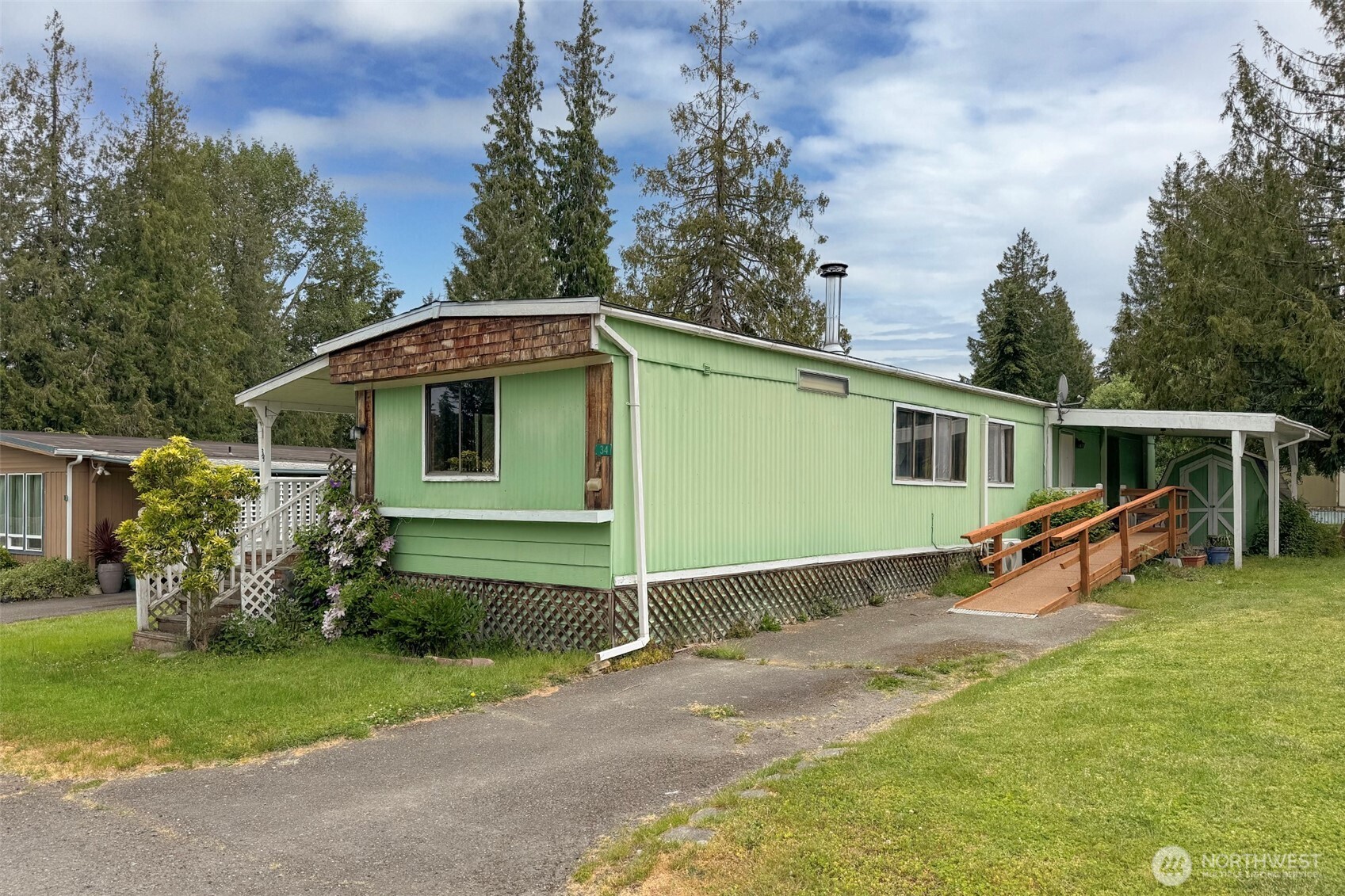 90 Baywood Village Road, Unit 34 Sequim, WA 98382 - Photo 3 of 40 a view of a house with backyard and trees