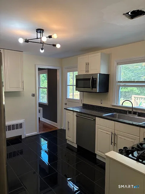 663 High Ridge Road Stamford, CT 06905 - Photo 8 of 8 a kitchen with kitchen island granite countertop a stove a sink and a microwave