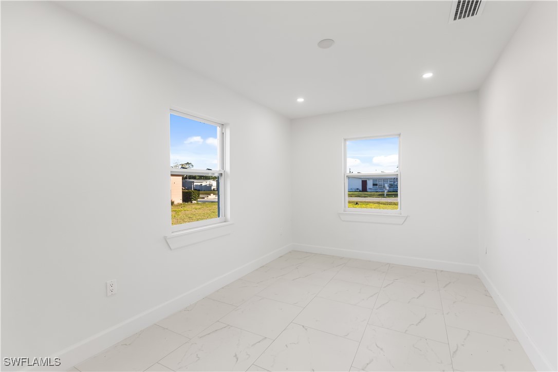 100 Wyoming Road Lehigh Acres, FL 33936 - Photo 13 of 38 an empty room with windows