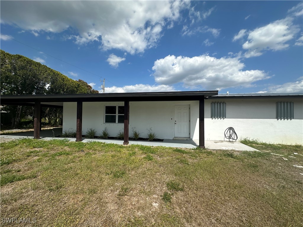 100 Wyoming Road Lehigh Acres, FL 33936 - Photo 2 of 38 a house view with a garden space