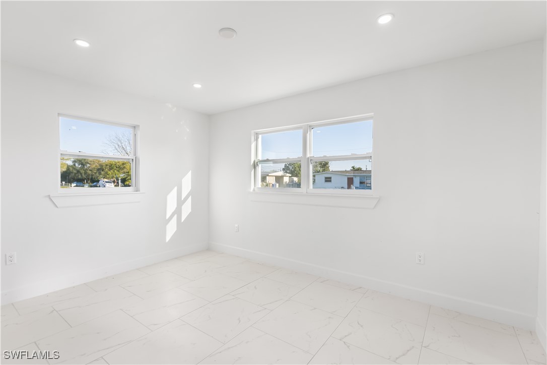 100 Wyoming Road Lehigh Acres, FL 33936 - Photo 24 of 38 an empty room with windows