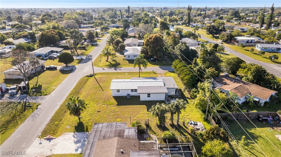 100 Wyoming Road Lehigh Acres, FL 33936 - Photo 30 of 38 an aerial view of a swimming pool with outdoor seating and yard