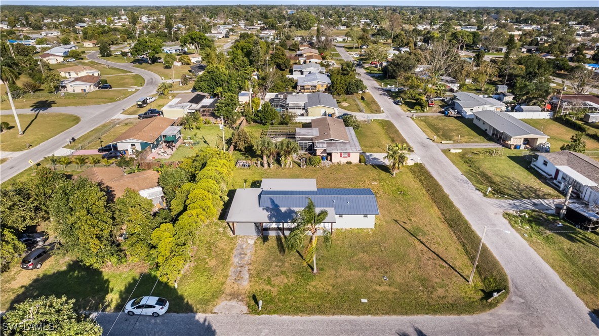 100 Wyoming Road Lehigh Acres, FL 33936 - Photo 35 of 38 an aerial view of residential houses with outdoor space