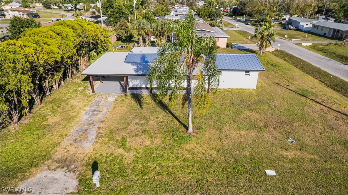 100 Wyoming Road Lehigh Acres, FL 33936 - Photo 36 of 38 a view of a house with a swimming pool