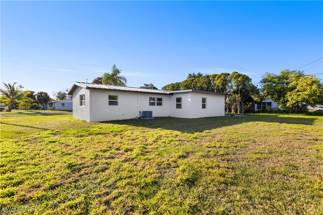 100 Wyoming Road Lehigh Acres, FL 33936 - Photo 38 of 38 a front view of a house with a yard
